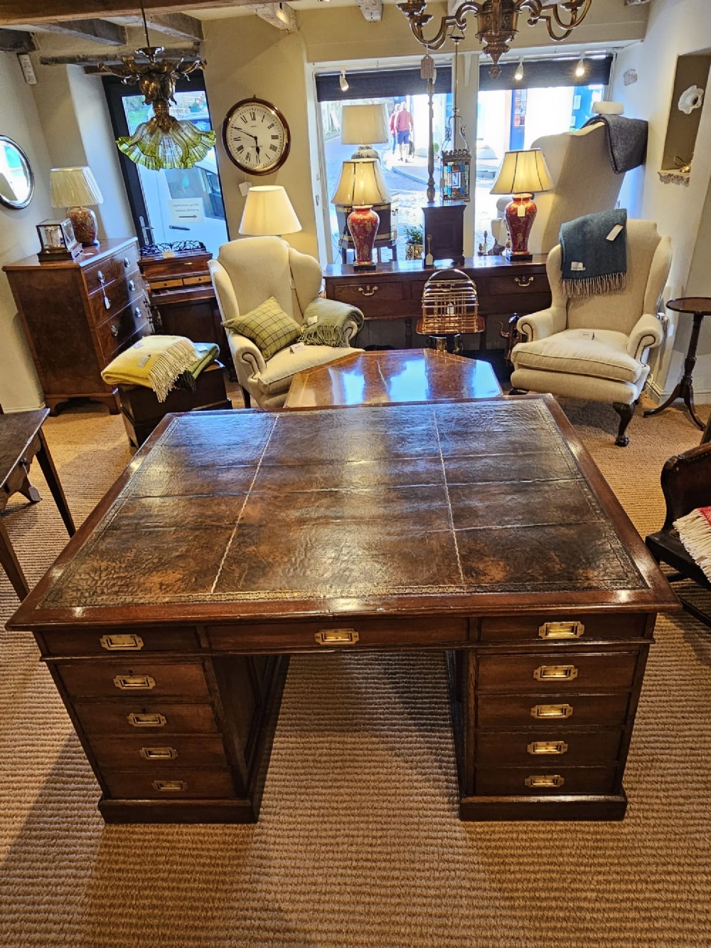 A large Victorian dark oak partners desk featuring dual twin pedestals, inset brass campaign handles, and a leather-topped writing surface. View II