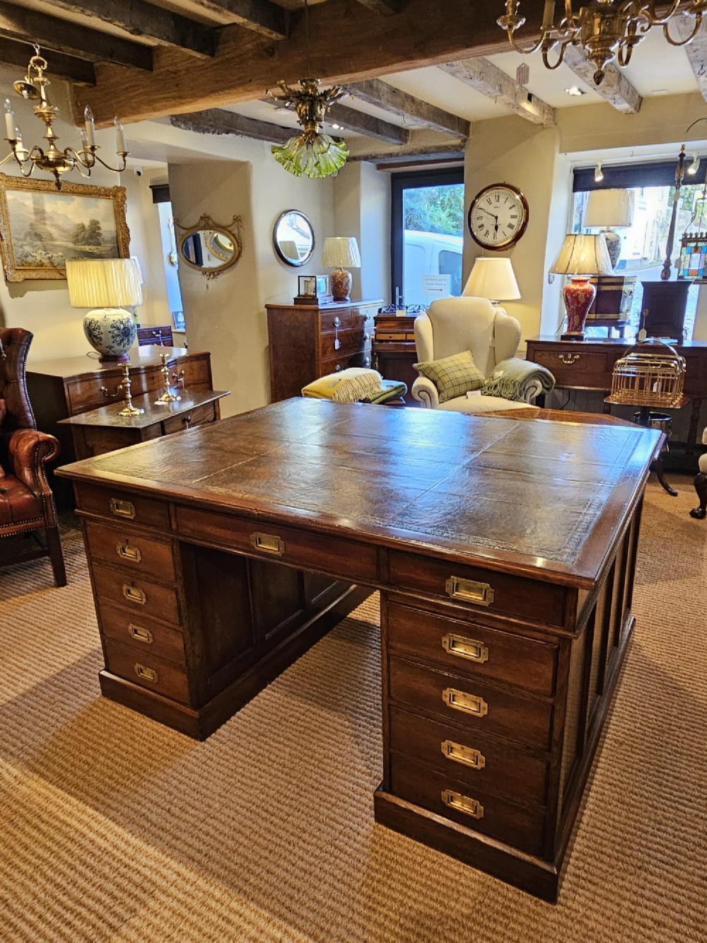 A large Victorian dark oak partners desk featuring dual twin pedestals, inset brass campaign handles, and a leather-topped writing surface. View III