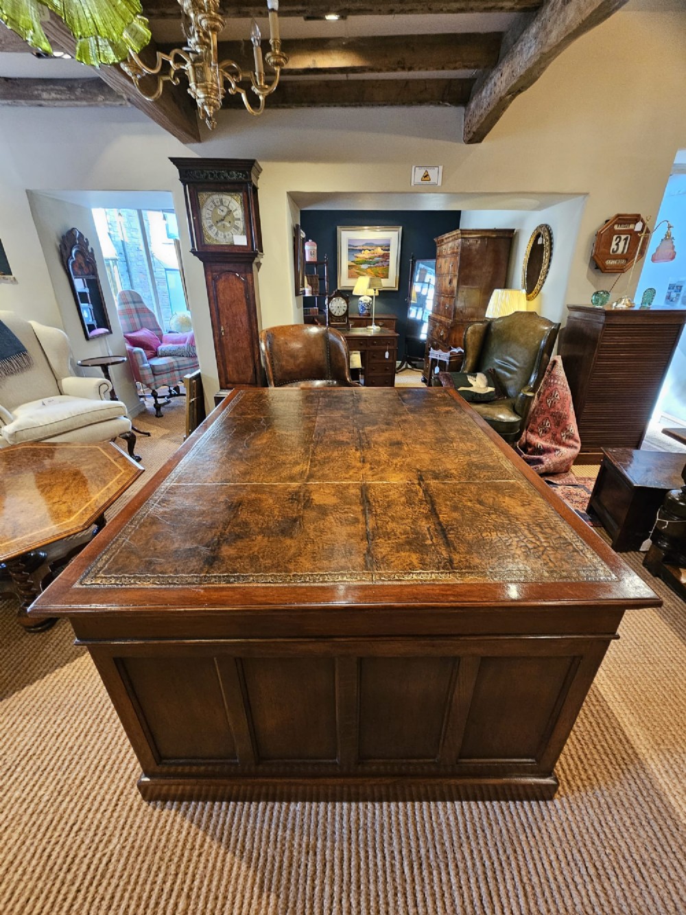 A large Victorian dark oak partners desk featuring dual twin pedestals, inset brass campaign handles, and a leather-topped writing surface. View IV