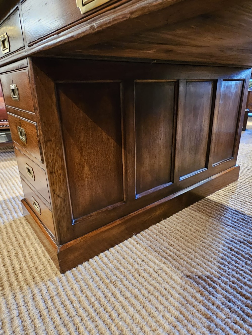 A large Victorian dark oak partners desk featuring dual twin pedestals, inset brass campaign handles, and a leather-topped writing surface. View VI