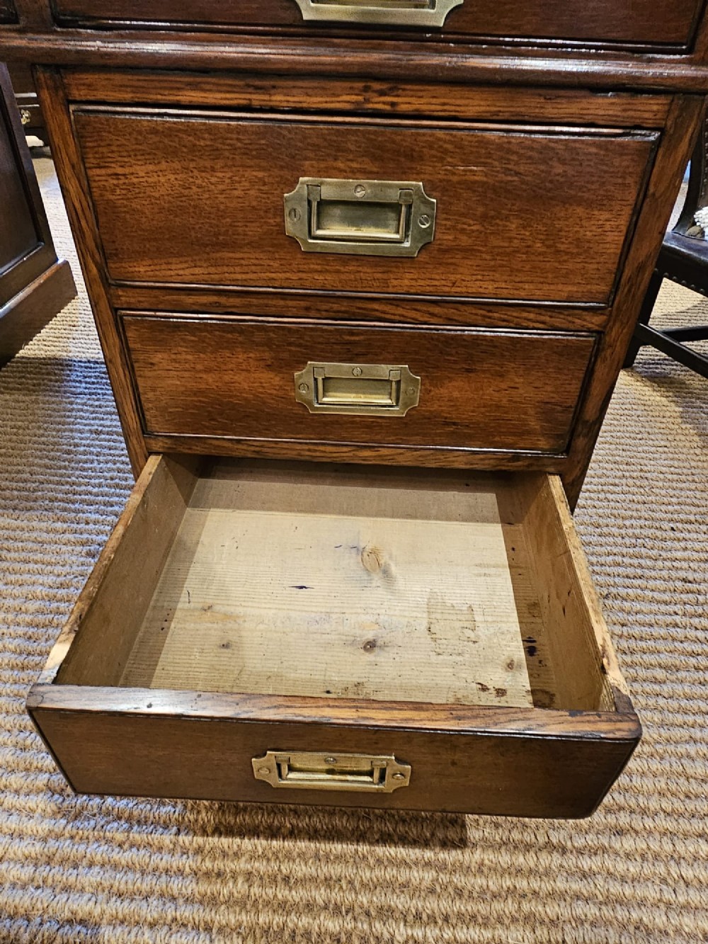 A large Victorian dark oak partners desk featuring dual twin pedestals, inset brass campaign handles, and a leather-topped writing surface. View VIII