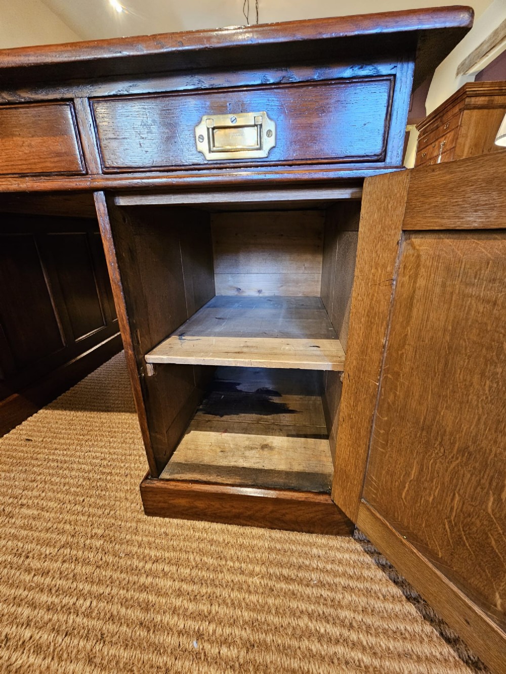 A large Victorian dark oak partners desk featuring dual twin pedestals, inset brass campaign handles, and a leather-topped writing surface. View IX