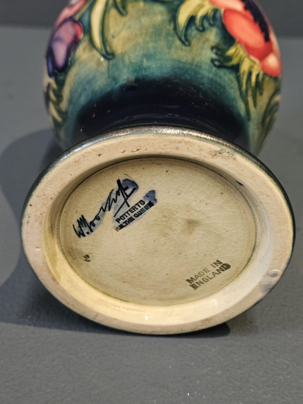 A small baluster-shaped ceramic vase featuring a tubelined red anemone motif against a ground fading from yellow-green to dark blue. View IV