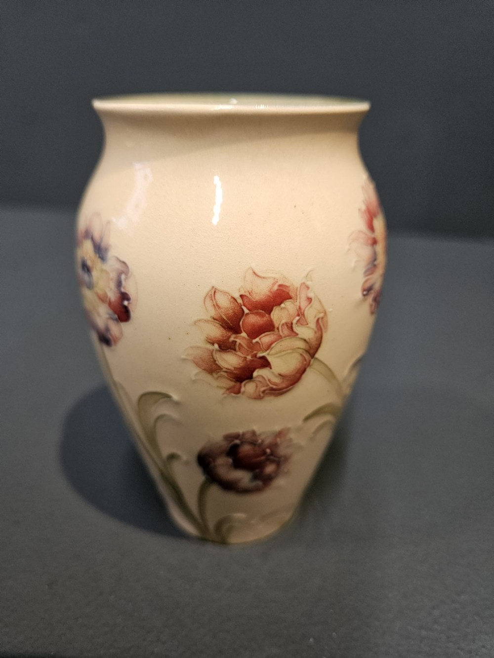 A cream earthenware vase decorated with tubelined pink cornflowers and green foliage in an Art Nouveau design. View VII