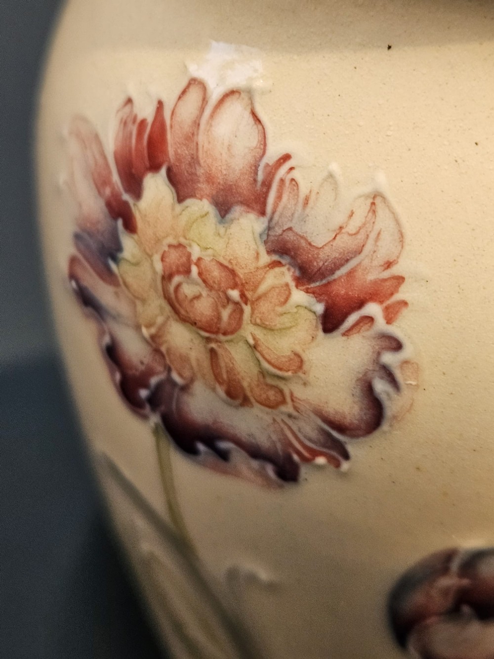 A cream earthenware vase decorated with tubelined pink cornflowers and green foliage in an Art Nouveau design. View VIII