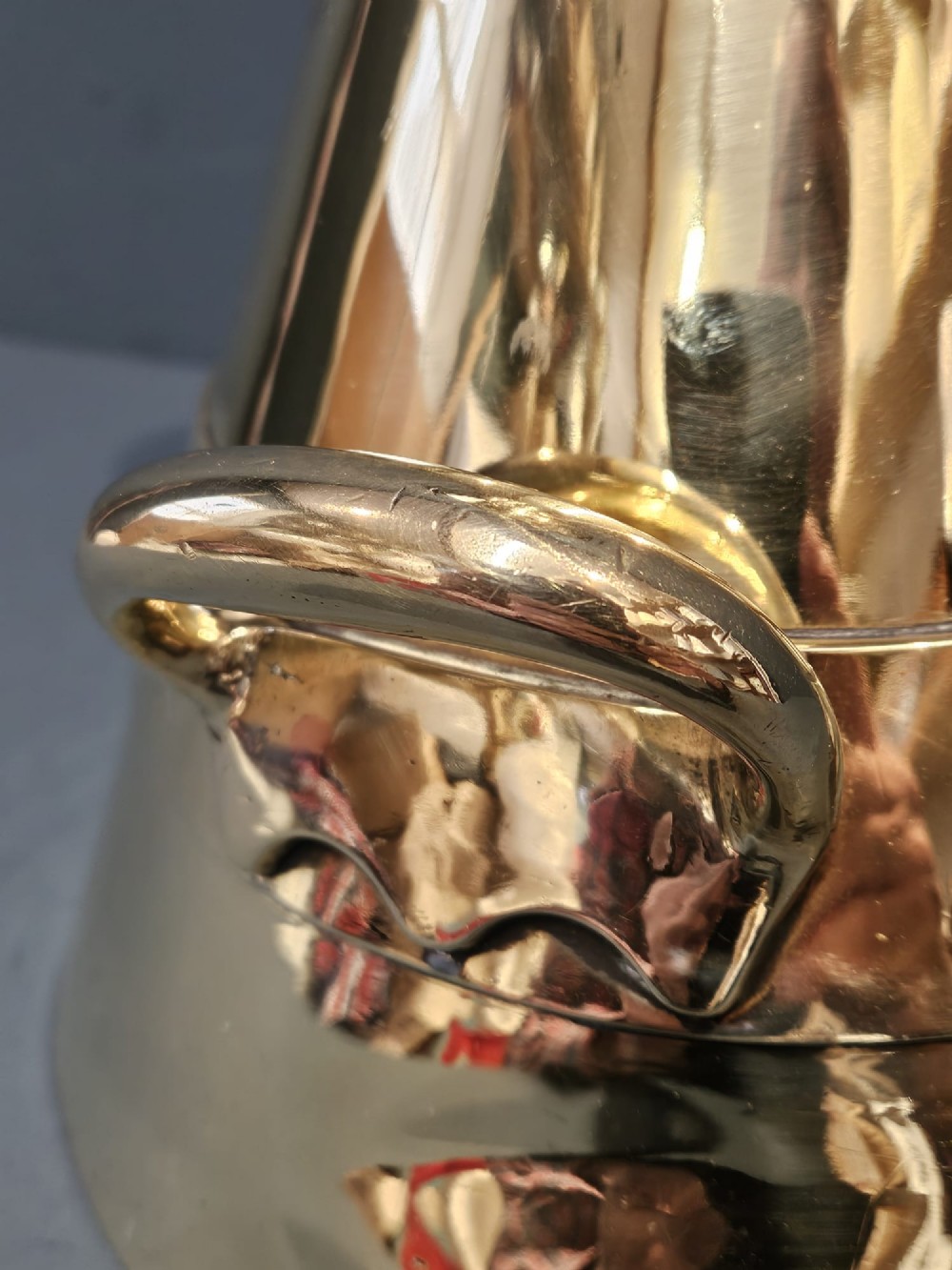 A polished Victorian brass one gallon capacity standard measure with a flared funnel top, conical body, twin loop handles, and official engravings. View VI