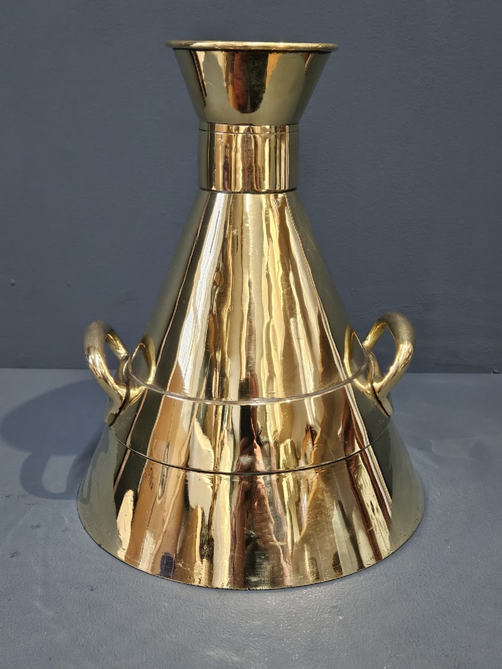 A polished Victorian brass one gallon capacity standard measure with a flared funnel top, conical body, twin loop handles, and official engravings. View VIII