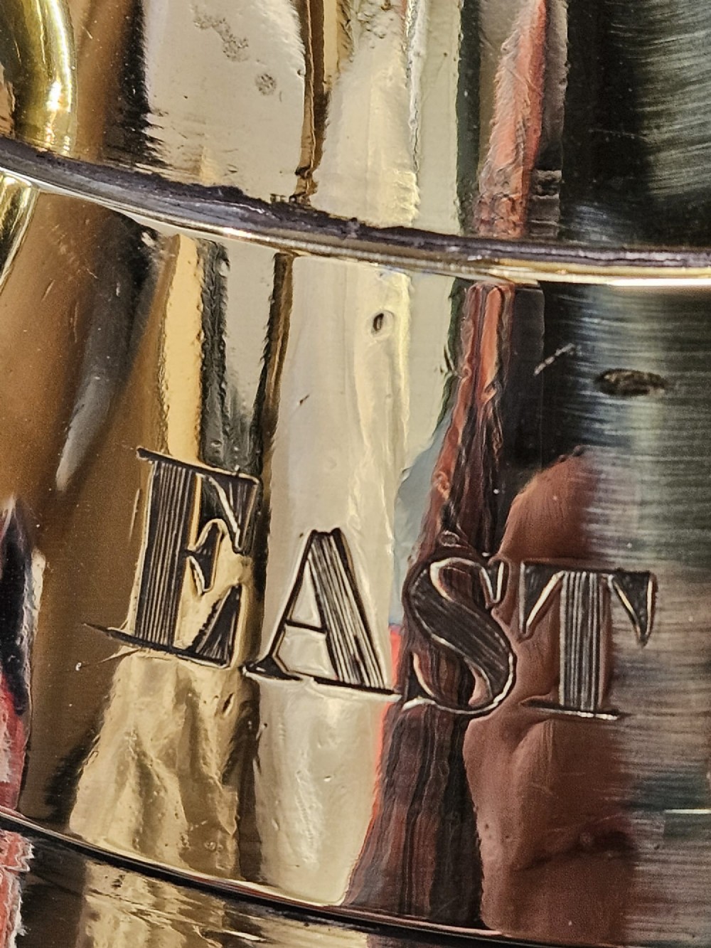 A polished Victorian brass one gallon capacity standard measure with a flared funnel top, conical body, twin loop handles, and official engravings. View X