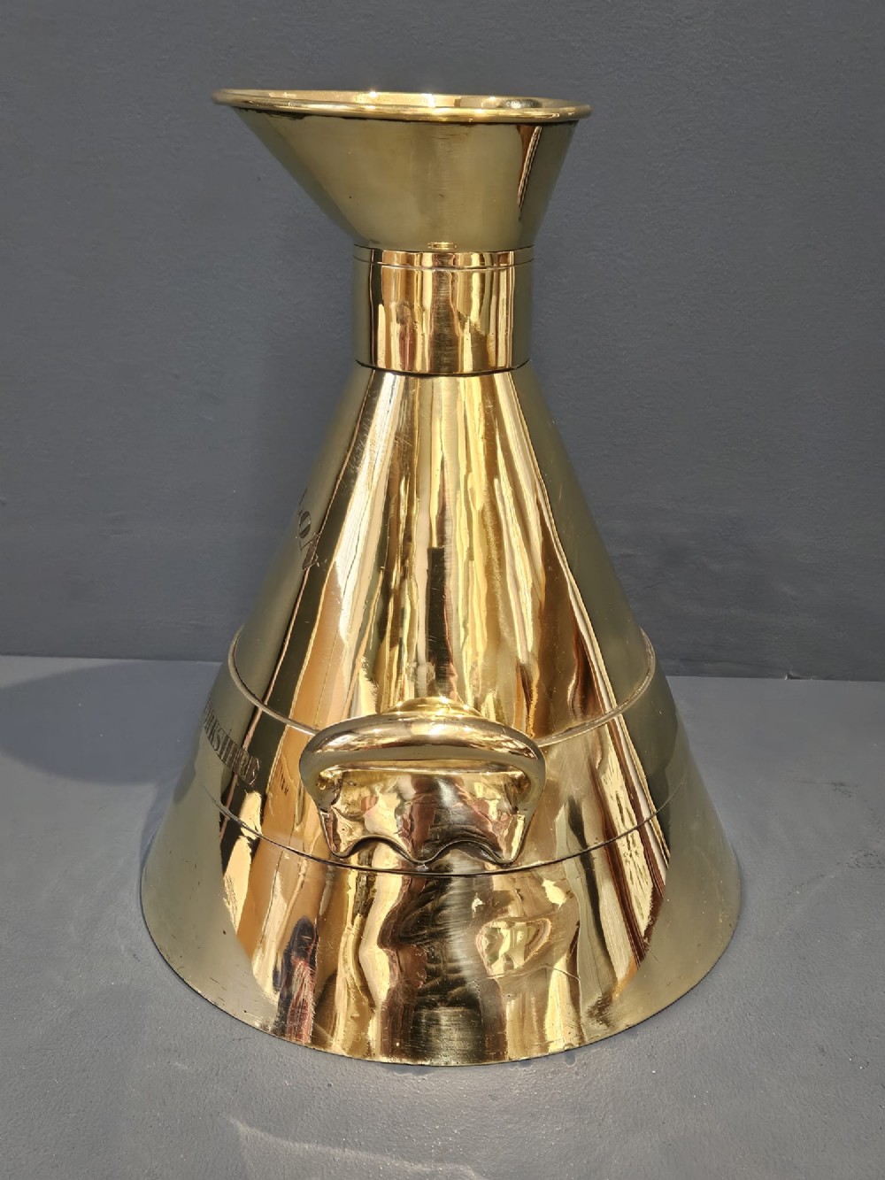 A polished Victorian brass one gallon capacity standard measure with a flared funnel top, conical body, twin loop handles, and official engravings. View XI