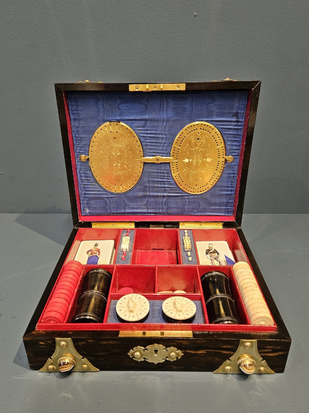 A dark coromandel wood box featuring decorative brass strapwork inset with rounded agate cabochons. View V