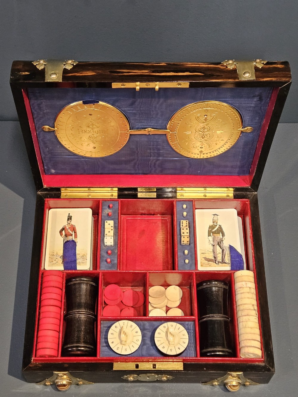 A dark coromandel wood box featuring decorative brass strapwork inset with rounded agate cabochons. View VII