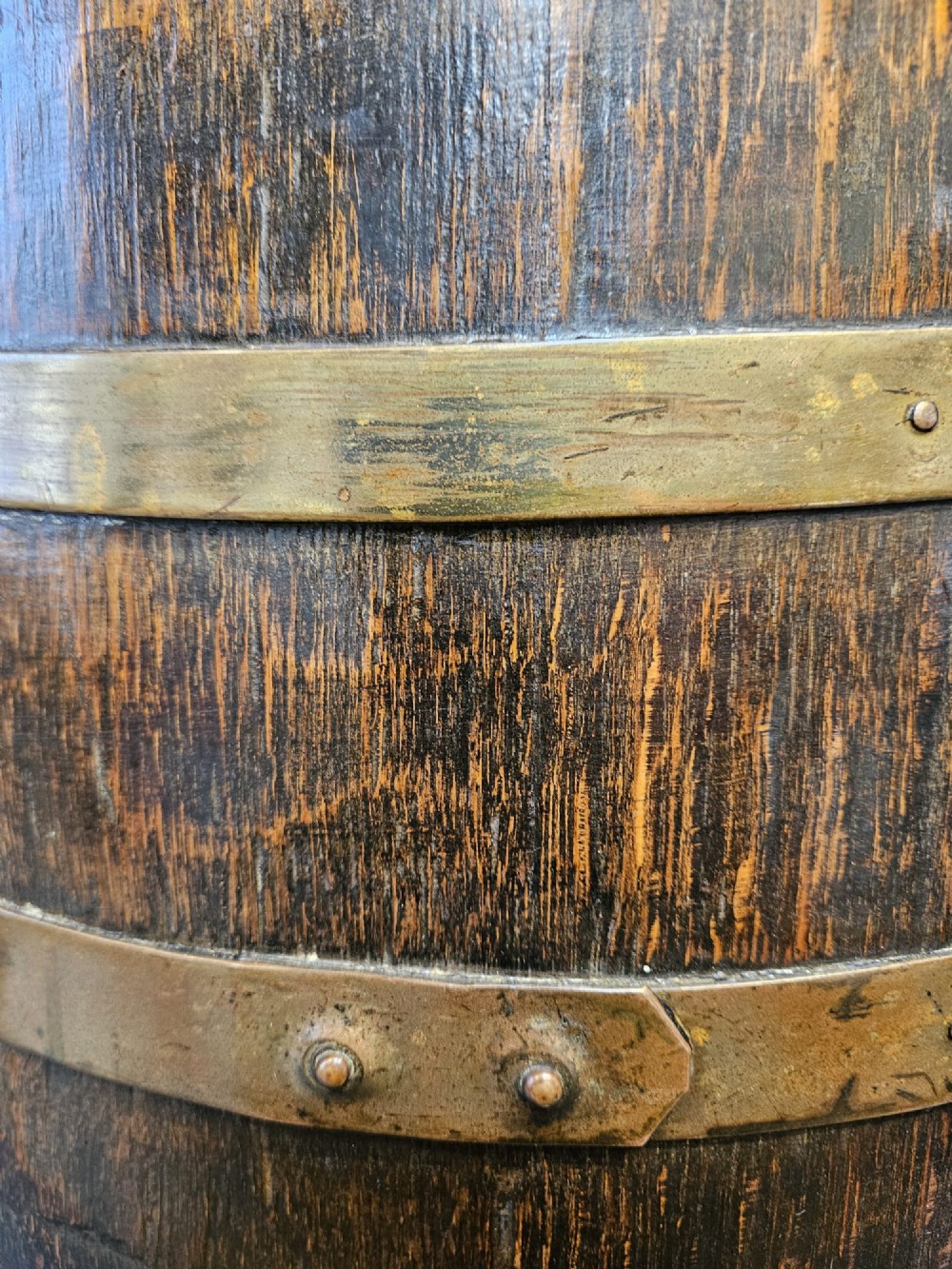 A Victorian dark oak coopered barrel stick stand fitted with brass hoops and displaying a royal coat of arms crest on the front. View III