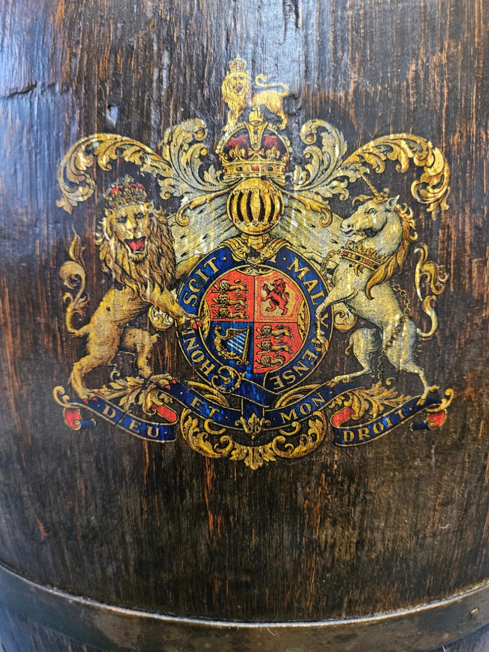 A Victorian dark oak coopered barrel stick stand fitted with brass hoops and displaying a royal coat of arms crest on the front. View IV