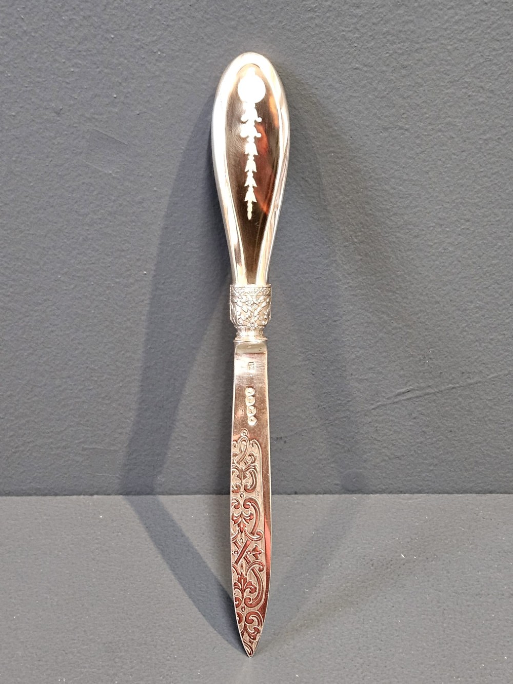 A Victorian silver and tortoiseshell paper knife featuring an engraved silver blade with hallmarks and an inlaid tortoiseshell handle.