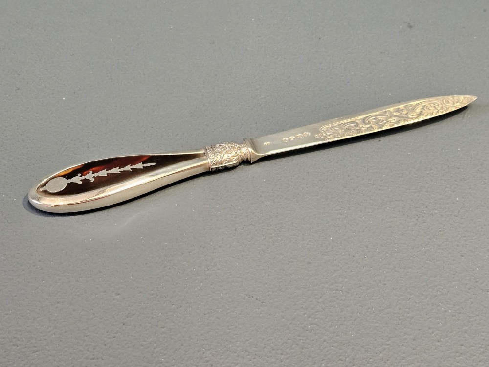 A Victorian silver and tortoiseshell paper knife featuring an engraved silver blade with hallmarks and an inlaid tortoiseshell handle. View II