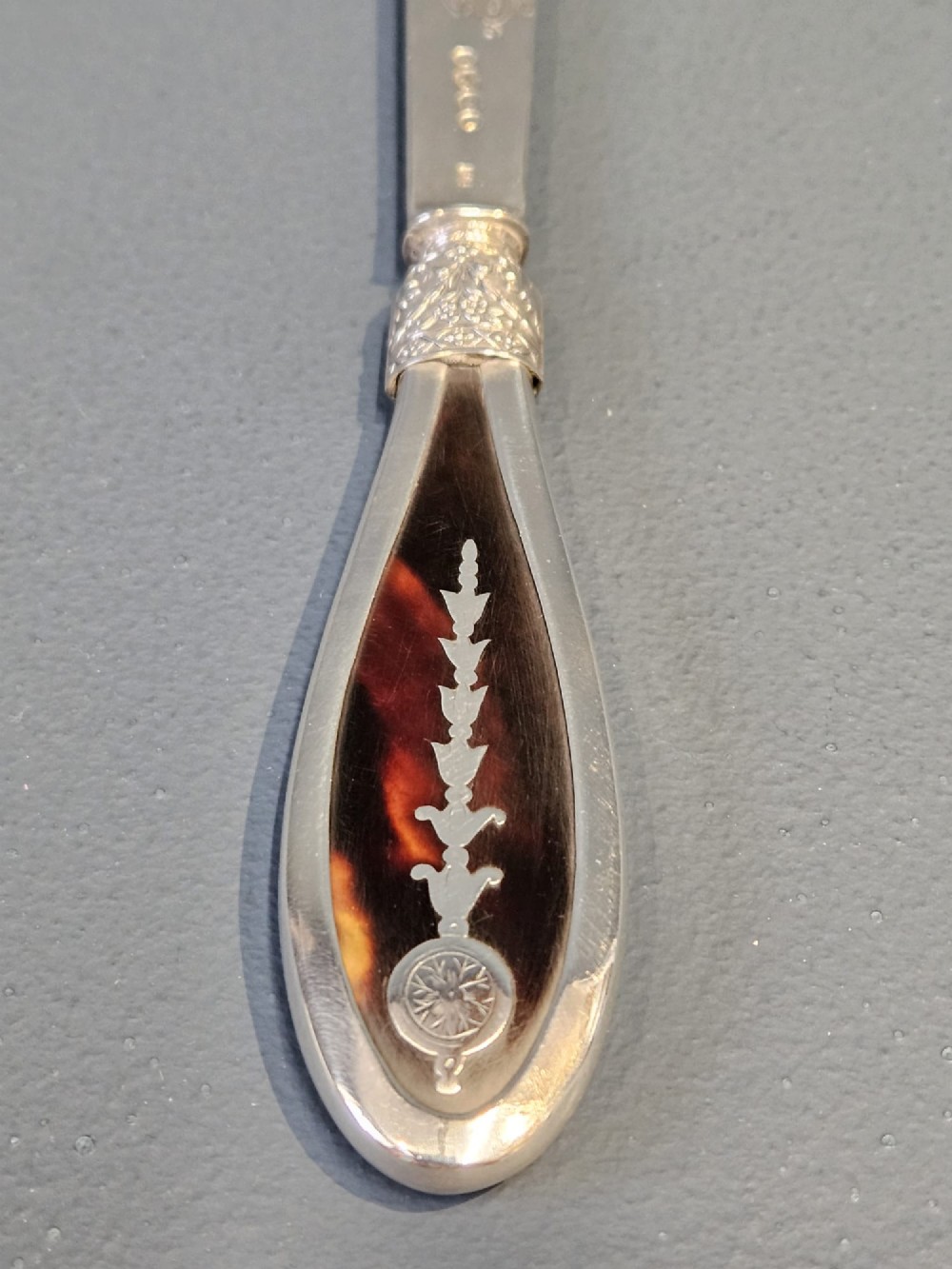 A Victorian silver and tortoiseshell paper knife featuring an engraved silver blade with hallmarks and an inlaid tortoiseshell handle. View III