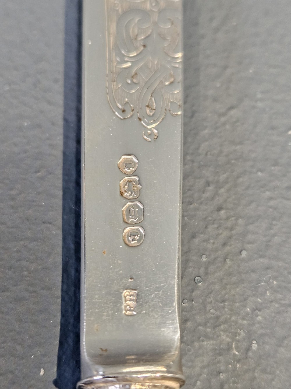 A Victorian silver and tortoiseshell paper knife featuring an engraved silver blade with hallmarks and an inlaid tortoiseshell handle. View VI
