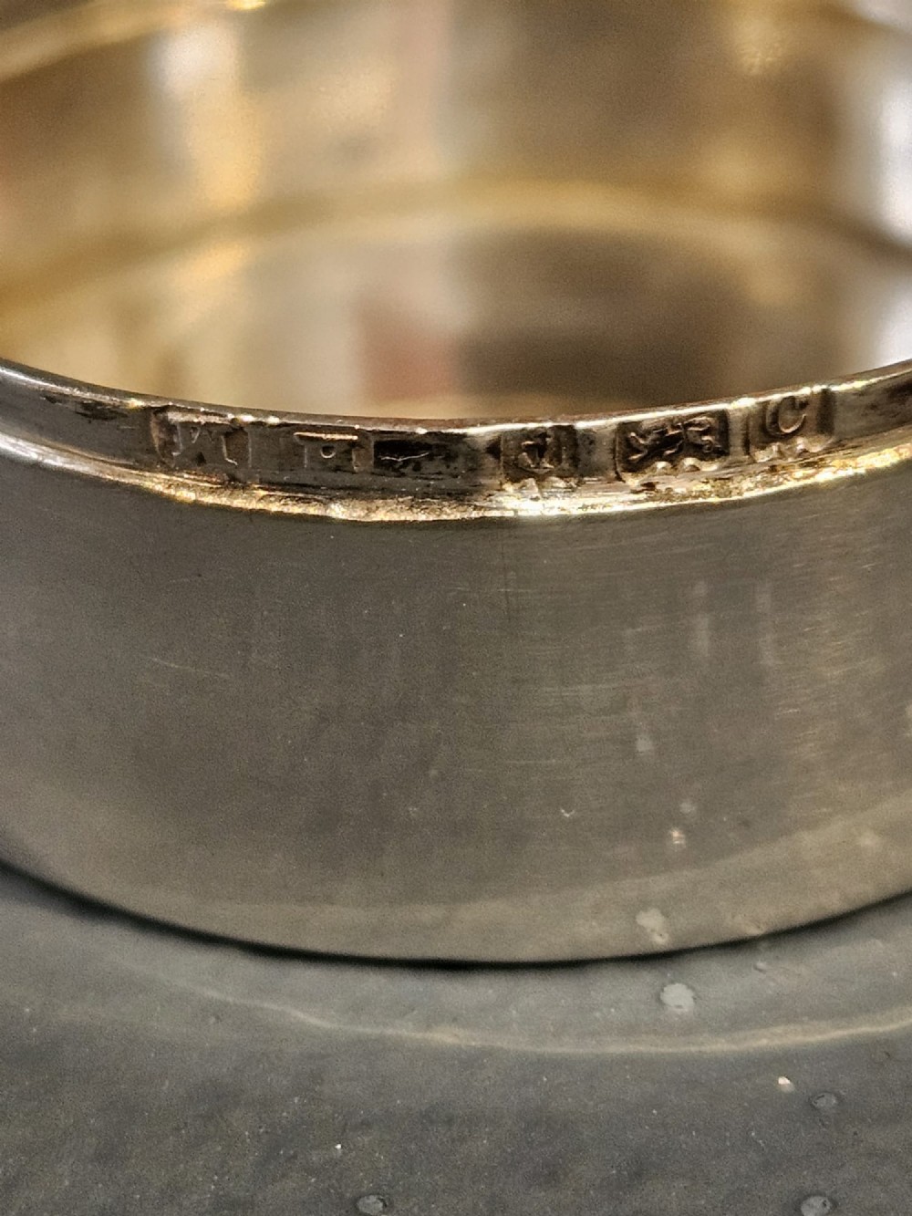 A circular silver pill box featuring an embossed Art Nouveau profile of a woman with flowing hair and flora on the top lid. View III