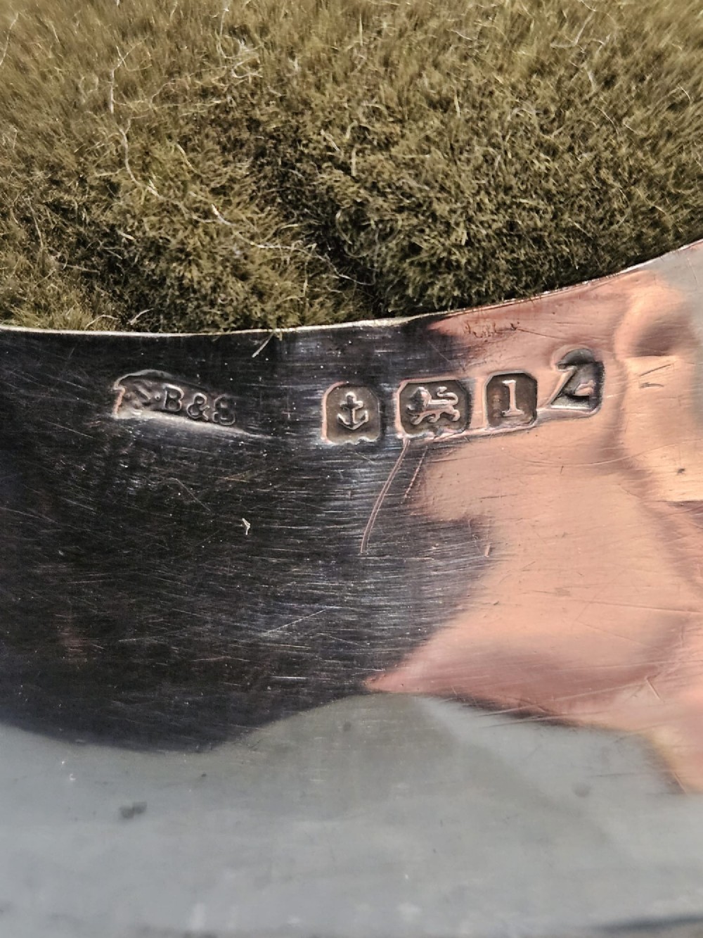 An Edwardian hallmarked sterling silver pin cushion shaped like a gentlemans shoe with an olive green velvet cushion top. View II