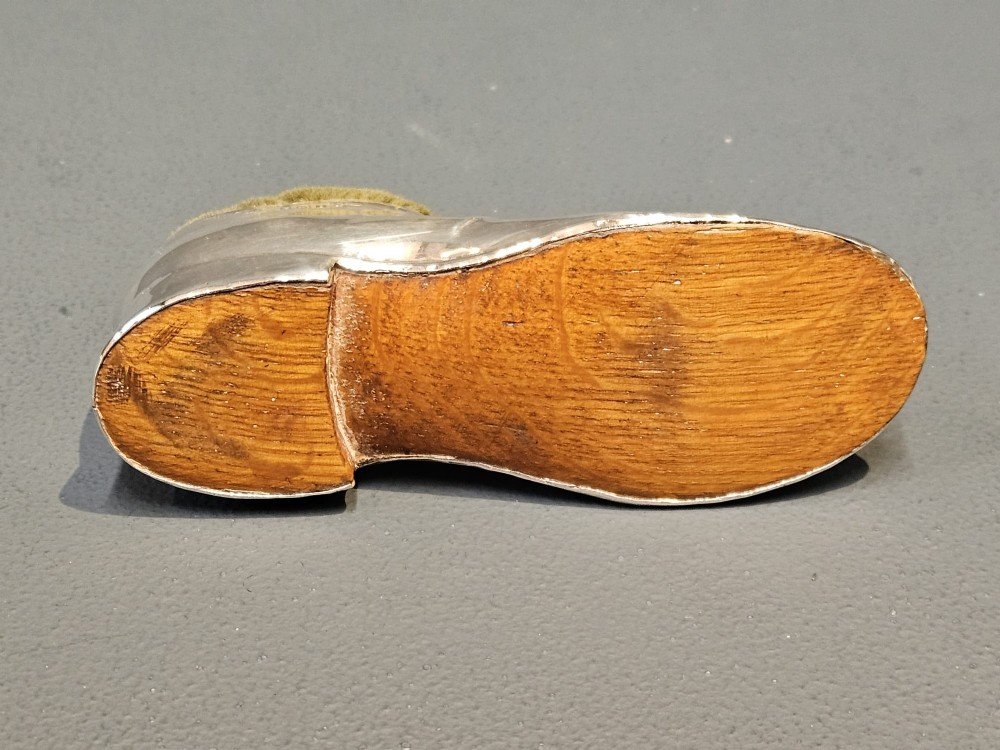 An Edwardian hallmarked sterling silver pin cushion shaped like a gentlemans shoe with an olive green velvet cushion top. View VI
