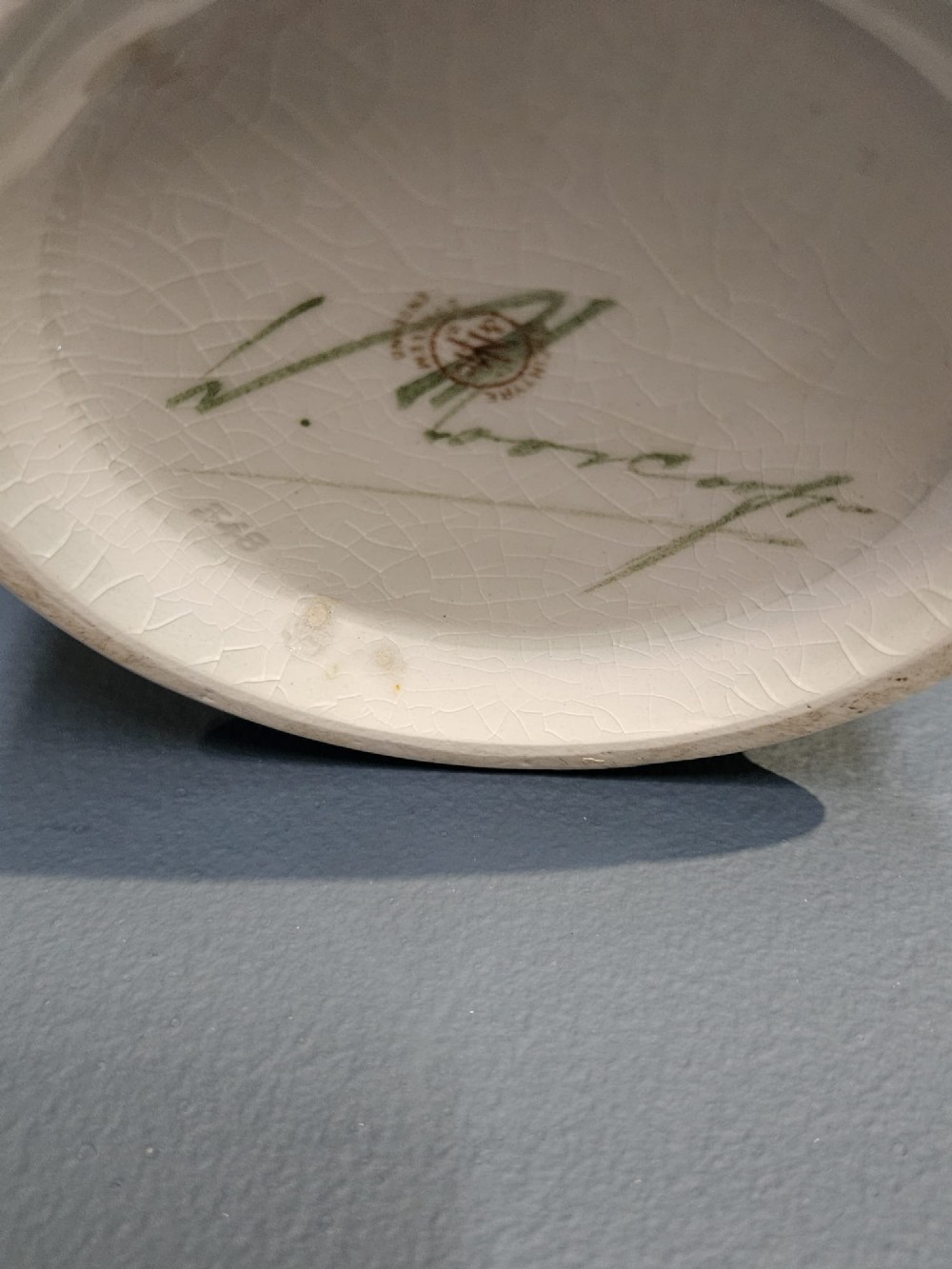 A bulbous ceramic vase featuring tube-lined blue cornflower motifs with green foliage set against a cream background. View III