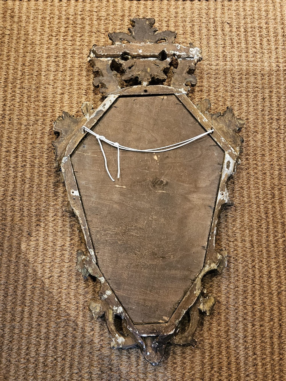 A mid-Victorian lozenge-shaped wall mirror featuring an ornate gold leaf giltwood frame decorated with scrolls and acanthus leaf cresting. View VII