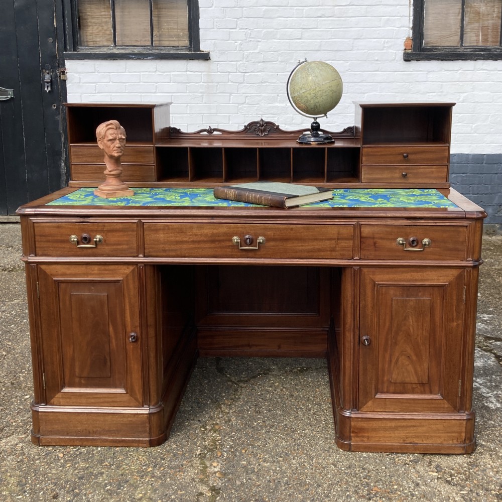 A mid-19th-century Italian mahogany pedestal desk featuring a raised superstructure with pigeonholes, frieze drawers, and twin pedestal cupboards. View XXI