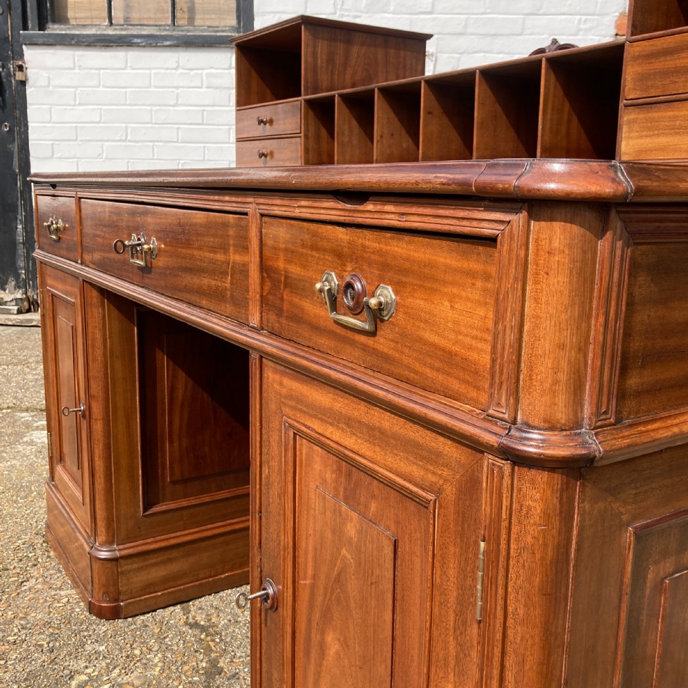 A mid-19th-century Italian mahogany pedestal desk featuring a raised superstructure with pigeonholes, frieze drawers, and twin pedestal cupboards. View VIII