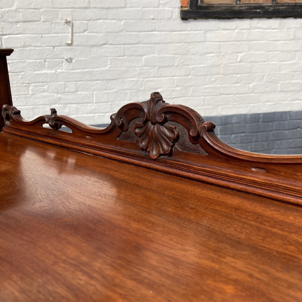 A mid-19th-century Italian mahogany pedestal desk featuring a raised superstructure with pigeonholes, frieze drawers, and twin pedestal cupboards. View X