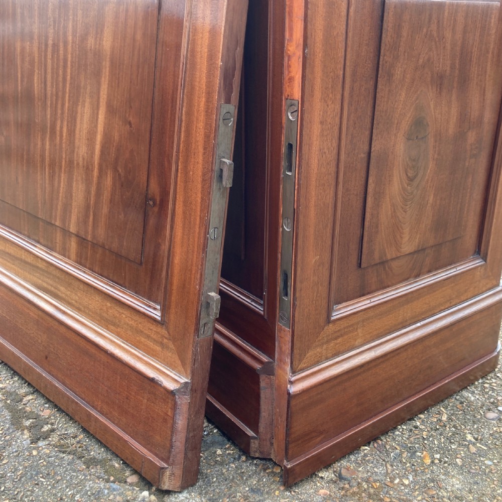 A mid-19th-century Italian mahogany pedestal desk featuring a raised superstructure with pigeonholes, frieze drawers, and twin pedestal cupboards. View XIX