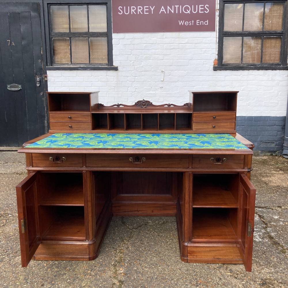 A mid-19th-century Italian mahogany pedestal desk featuring a raised superstructure with pigeonholes, frieze drawers, and twin pedestal cupboards. View XX