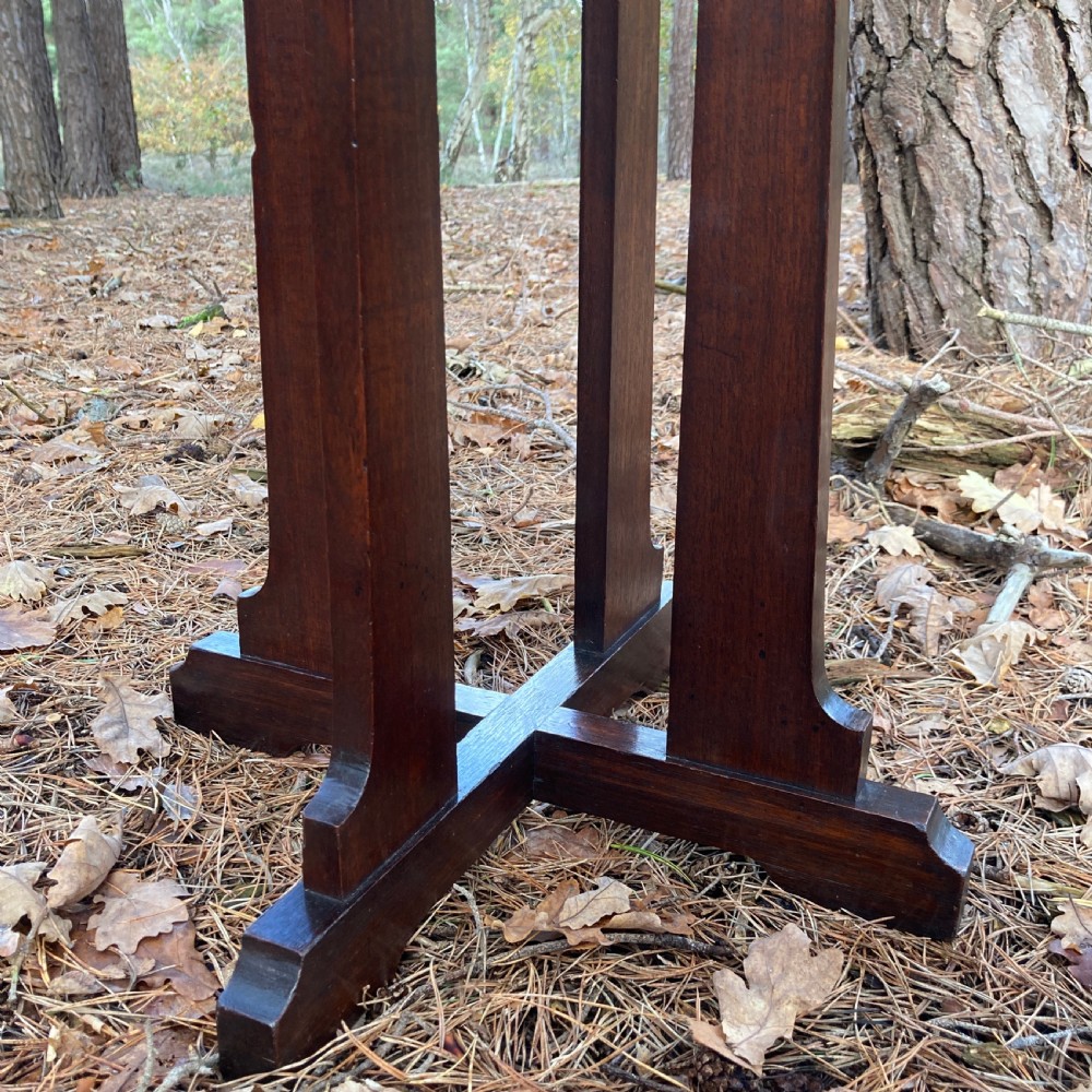 An antique Cotswold School octagonal rosewood occasional table featuring slender straight legs and a cross-shaped base. View V