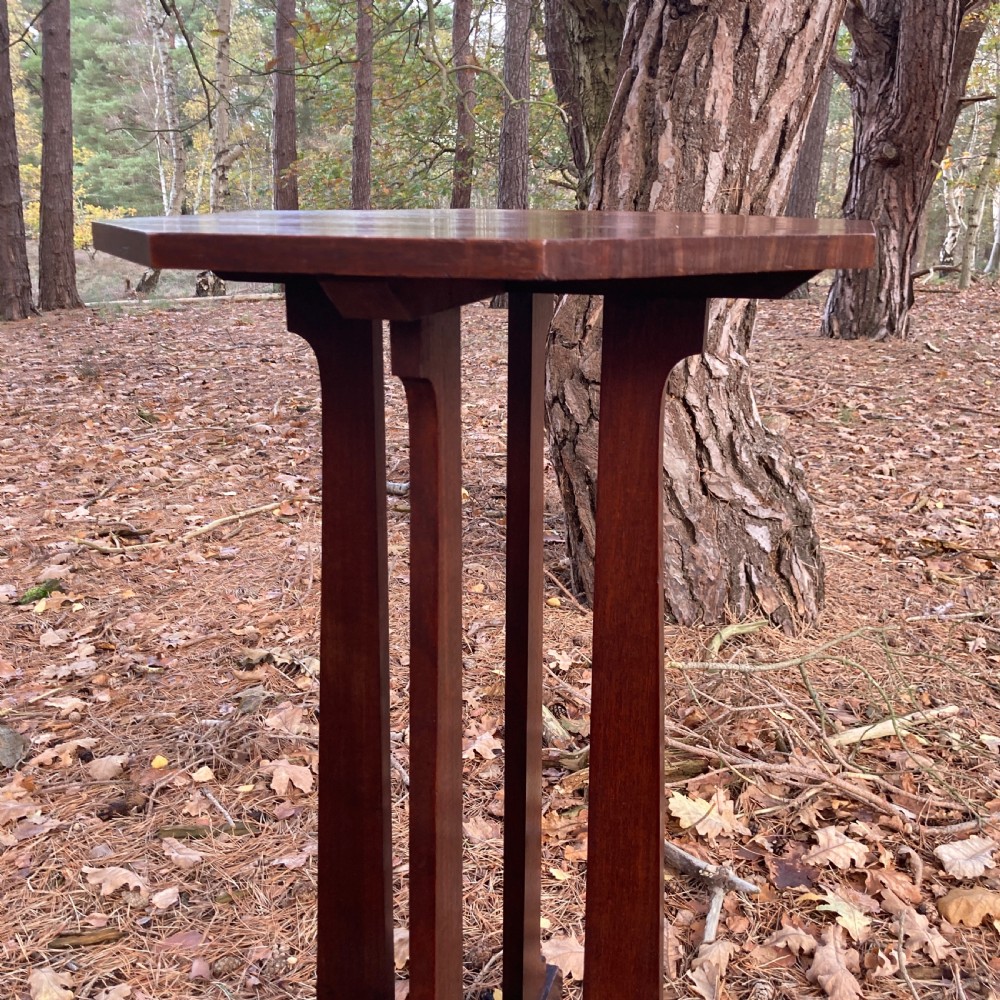An antique Cotswold School octagonal rosewood occasional table featuring slender straight legs and a cross-shaped base. View VI