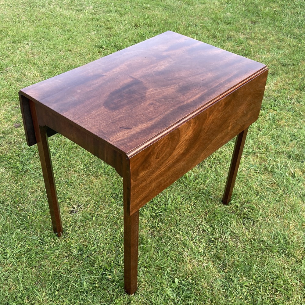A Georgian mahogany Pembroke table featuring two drop-leaf sides and four square tapered legs. View III