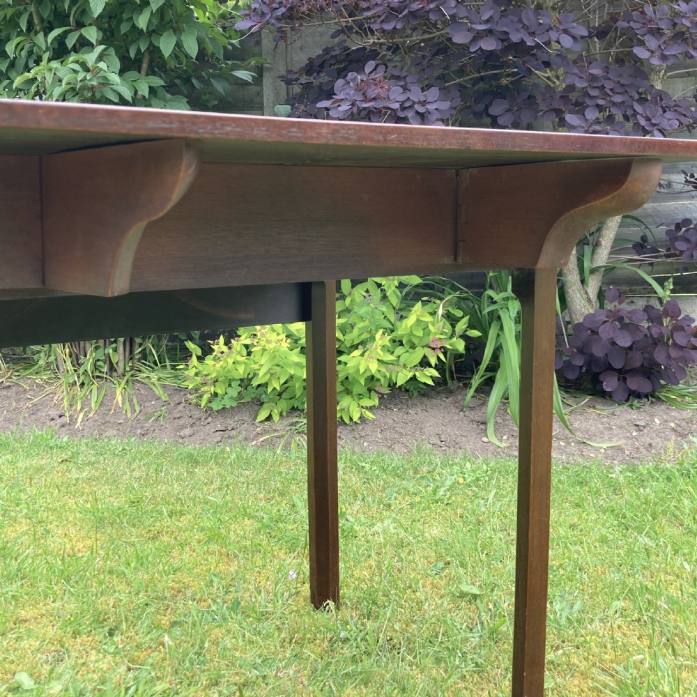 A Georgian mahogany Pembroke table featuring two drop-leaf sides and four square tapered legs. View XIII