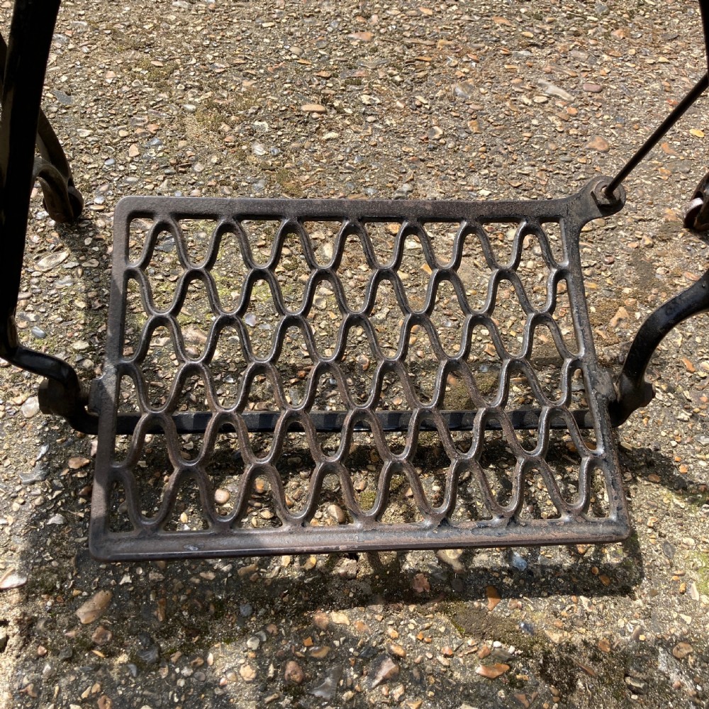 An oak-cased Singer sewing machine side table with side drawers mounted on a black cast iron treadle base. View XI