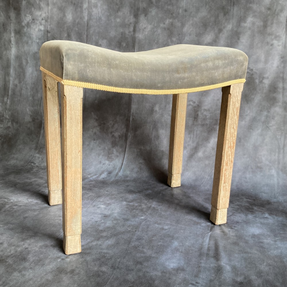 A 1937 King George VI coronation stool featuring a limed oak frame, chamfered legs, and a concave velvet seat edged with gold braid. View II