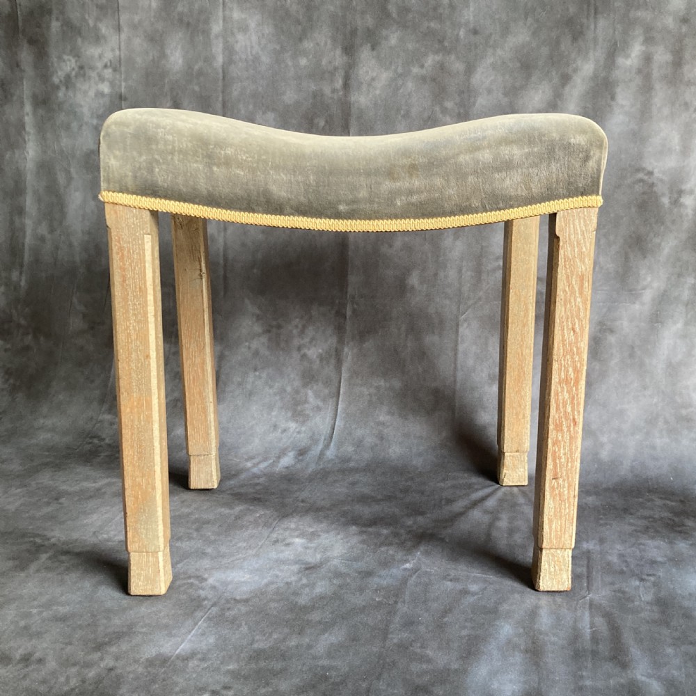 A 1937 King George VI coronation stool featuring a limed oak frame, chamfered legs, and a concave velvet seat edged with gold braid. View V