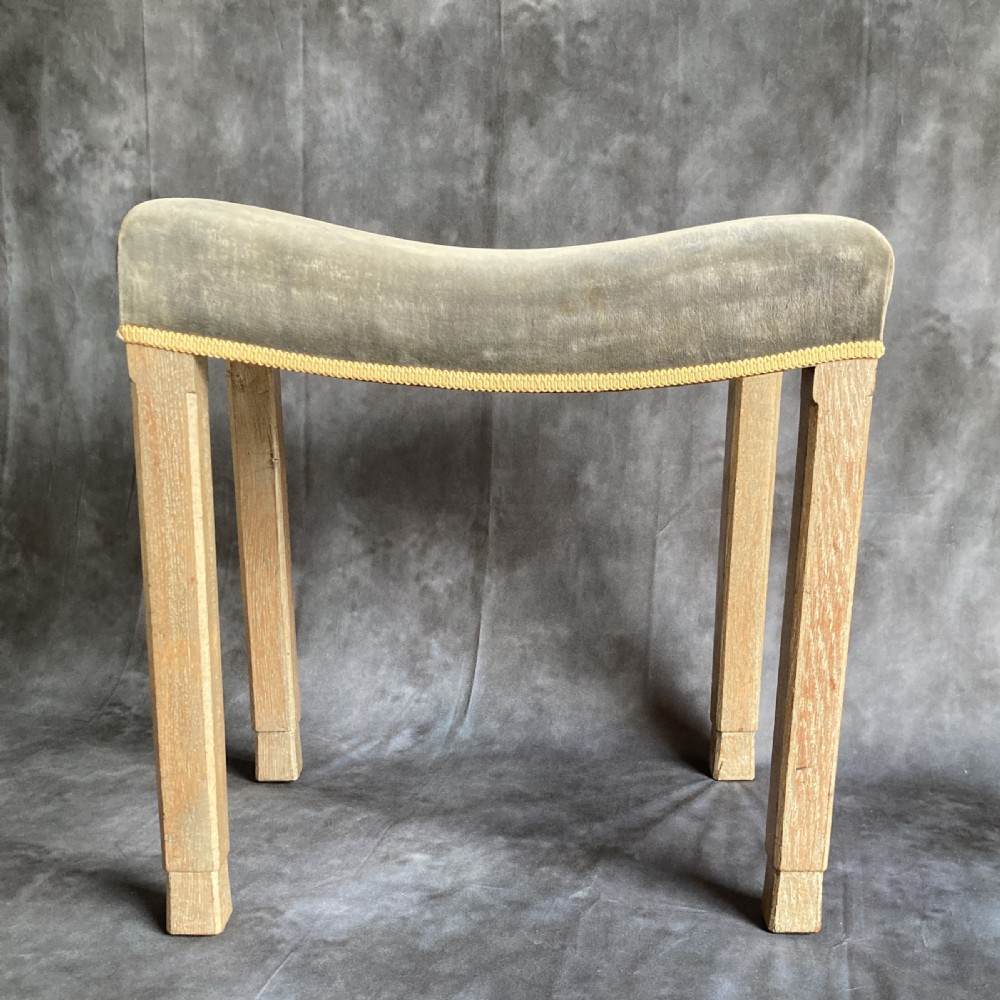 A 1937 King George VI coronation stool featuring a limed oak frame, chamfered legs, and a concave velvet seat edged with gold braid. View VII