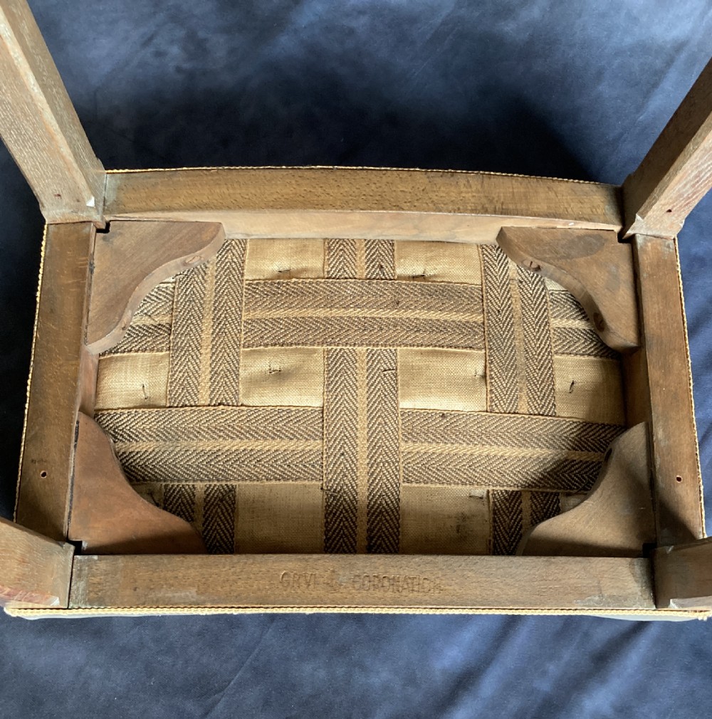 A 1937 King George VI coronation stool featuring a limed oak frame, chamfered legs, and a concave velvet seat edged with gold braid. View XIII