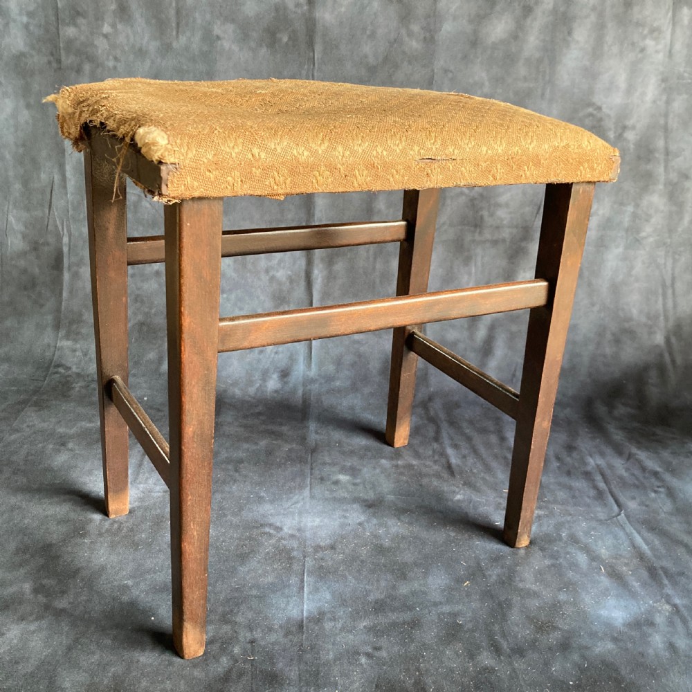 A pair of early 20th-century dark oak stools featuring patterned gold upholstery and rectangular tapered legs. View II
