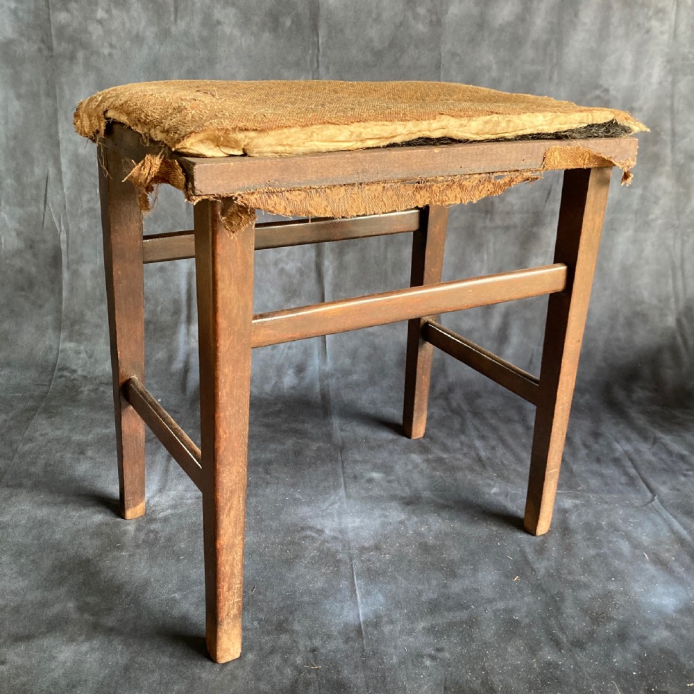 A pair of early 20th-century dark oak stools featuring patterned gold upholstery and rectangular tapered legs. View III