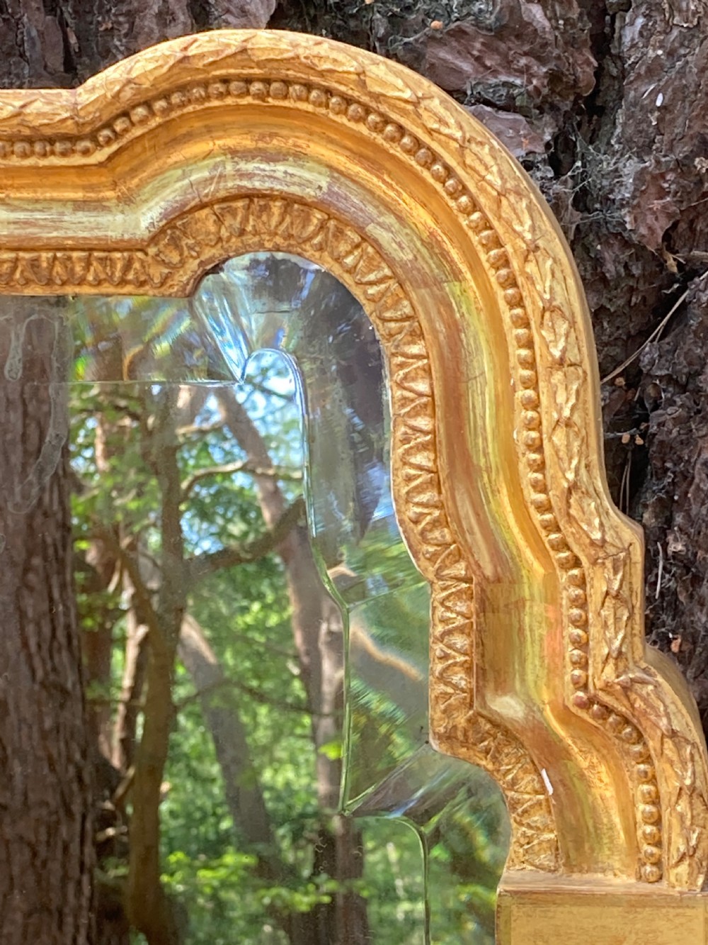 A tall late 18th-century giltwood pier glass mirror featuring fluted pilasters, classical capitals, and a shaped bevelled glass plate. View II