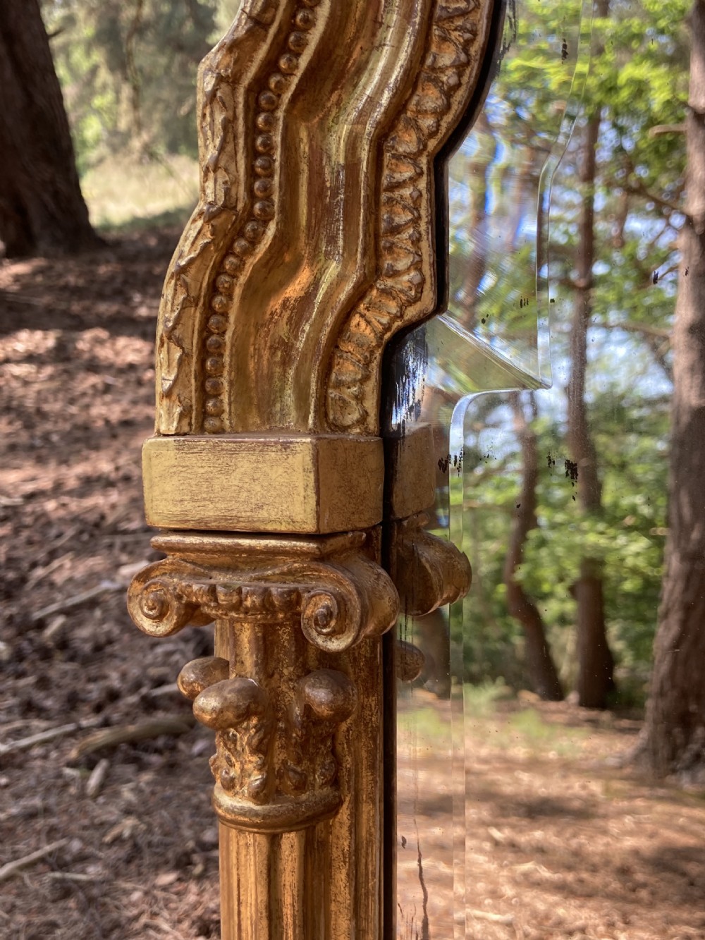 A tall late 18th-century giltwood pier glass mirror featuring fluted pilasters, classical capitals, and a shaped bevelled glass plate. View X