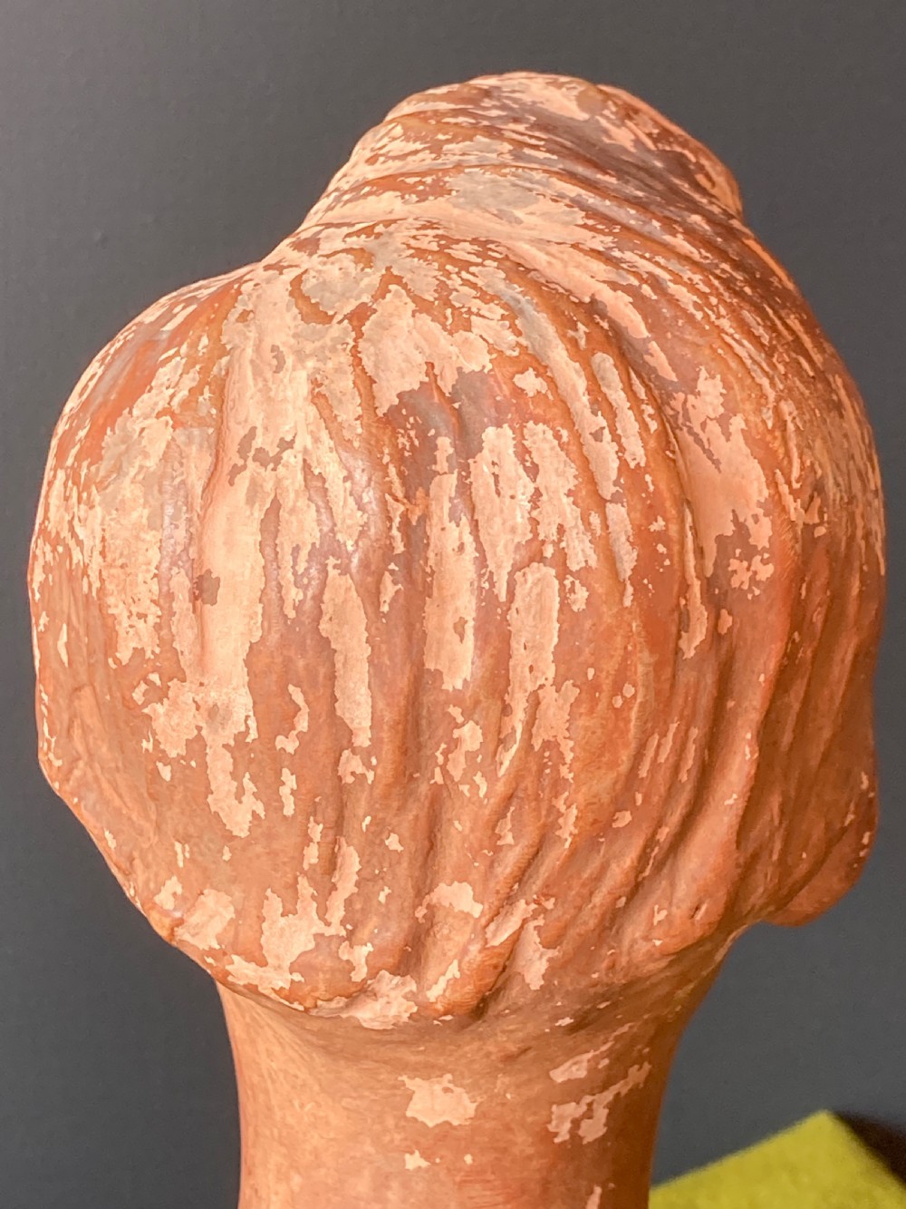 An Italian terracotta male portrait bust with swept hair and a distressed surface, set on a circular socle and square base. View VI