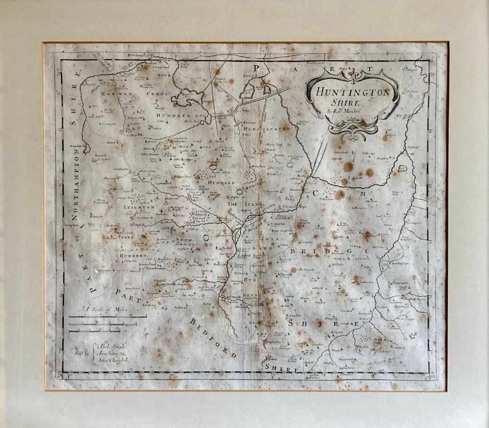 An 18th-century engraved map of Huntington Shire by Robert Morden, set within a cream mount and a dark wood frame with a gilt inner slip. View III