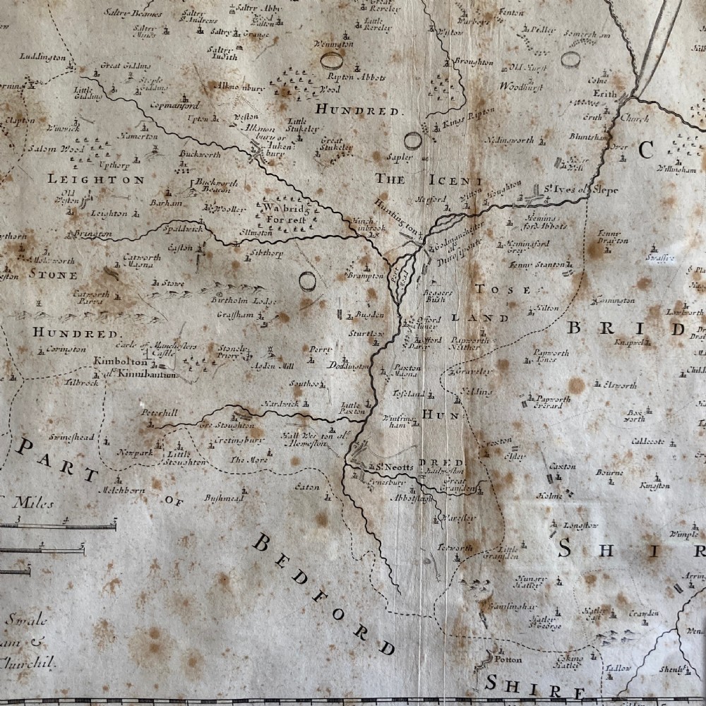 An 18th-century engraved map of Huntington Shire by Robert Morden, set within a cream mount and a dark wood frame with a gilt inner slip. View VI