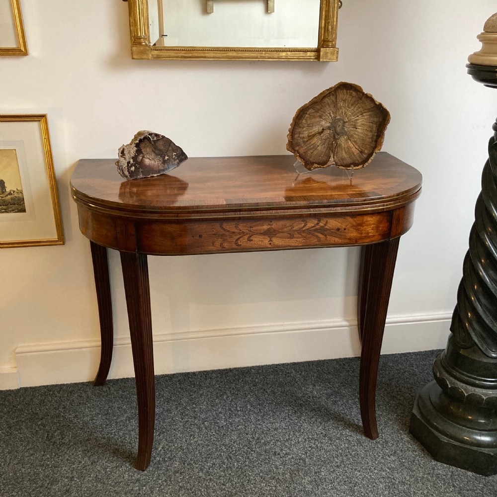 A late Georgian mahogany fold-over tea table featuring an inlaid apron and four reeded legs. View III