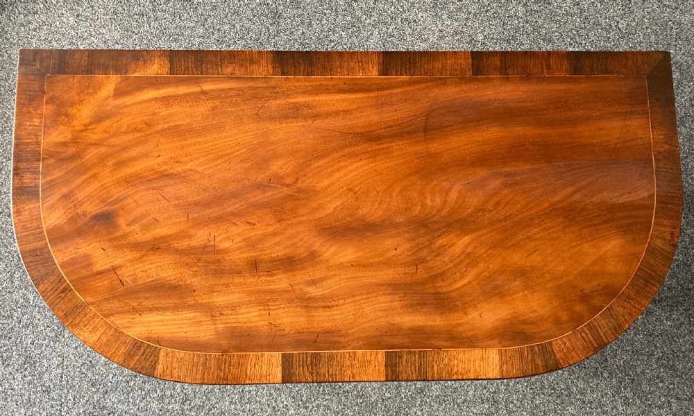 A late Georgian mahogany fold-over tea table featuring an inlaid apron and four reeded legs. View XI