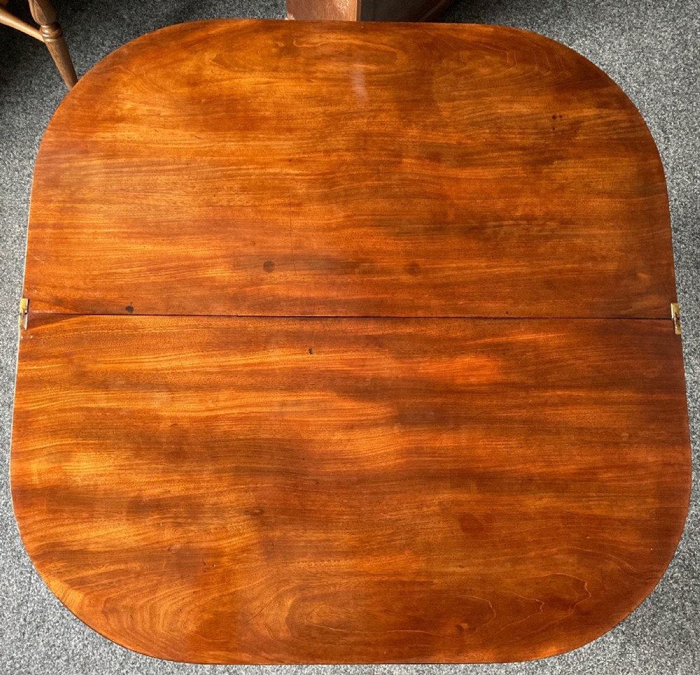 A late Georgian mahogany fold-over tea table featuring an inlaid apron and four reeded legs. View XII